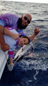 Hilly Awad and his daughter Amira Awad with the baby whale they had rescued. 