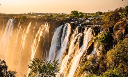 Waterfall and mountains hued in brown and gold