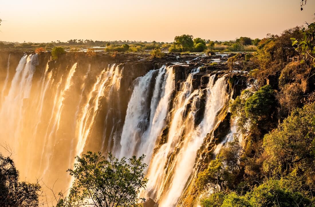 Waterfall and mountains hued in brown and gold
